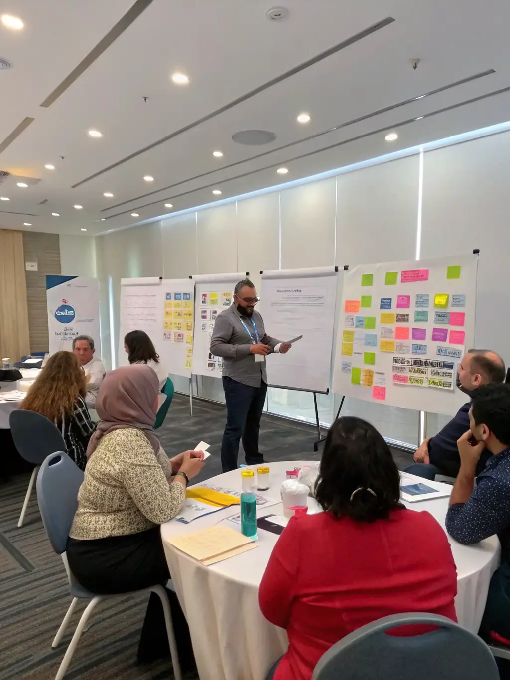 A consultant leading a workshop on change management strategies with a diverse group of participants, promoting smooth transitions.